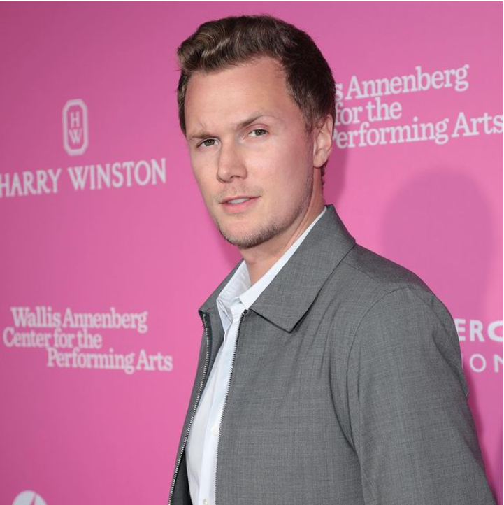 Barron Hilton Posing with a Pink Background