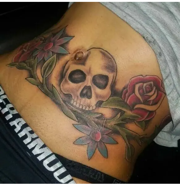 Skull Themed Tummy Tuck Tattoo
